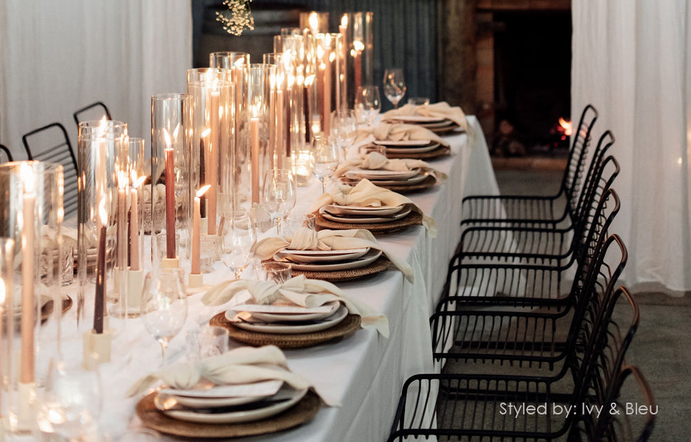 Image of long wedding table in barn with taper candles